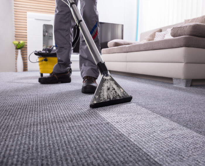 Low,Section,Of,A,Person,Cleaning,The,Carpet,With,Vacuum